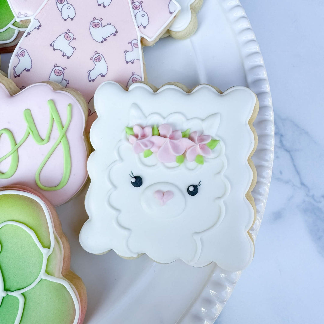 Decorated llama cookie with flower crown, perfect for baby showers and gifts.