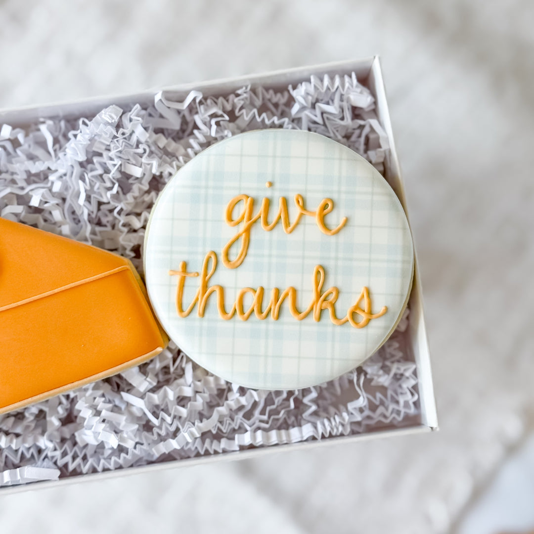 Decorated Thanksgiving cookie set featuring "Give Thanks" message from Southern Sugar Bakery, with festive autumn designs and colorful icing.