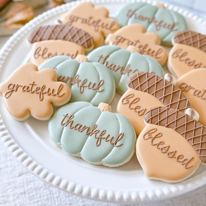 Decorated Thanksgiving cookie set featuring "Thankful," "Grateful," and "Blessed" messages from Southern Sugar Bakery.