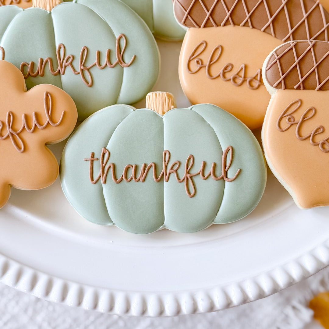 Decorated Thanksgiving cookie set by Southern Sugar Bakery featuring thankful, grateful, blessed themed cookies on a festive platter.
