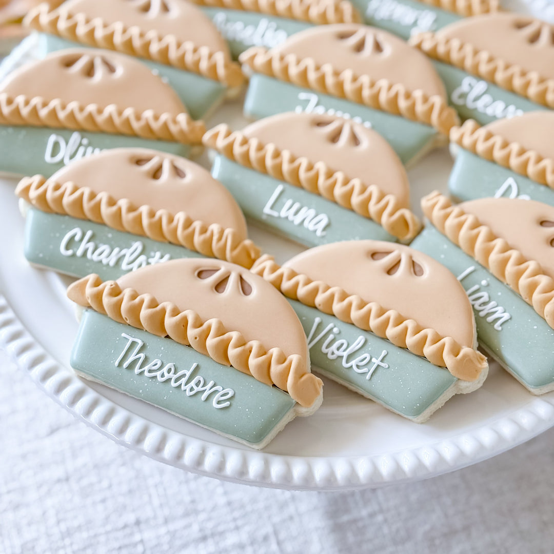 Set of decorated Thanksgiving cookie place cards from Southern Sugar Bakery featuring festive pie-themed designs.